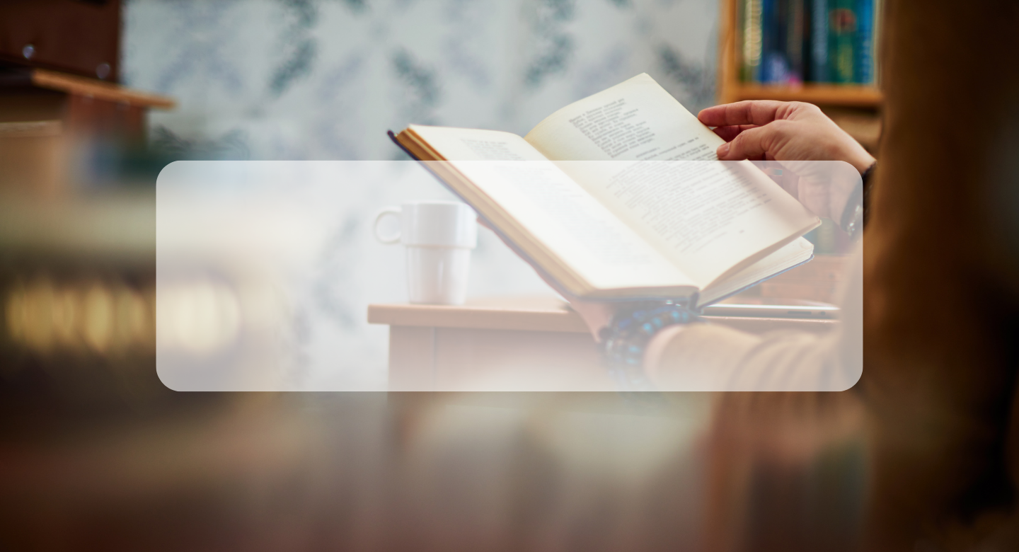 woman holding a book open in the library