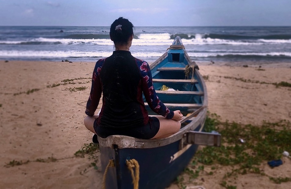 karina on a boat, facing the ocean