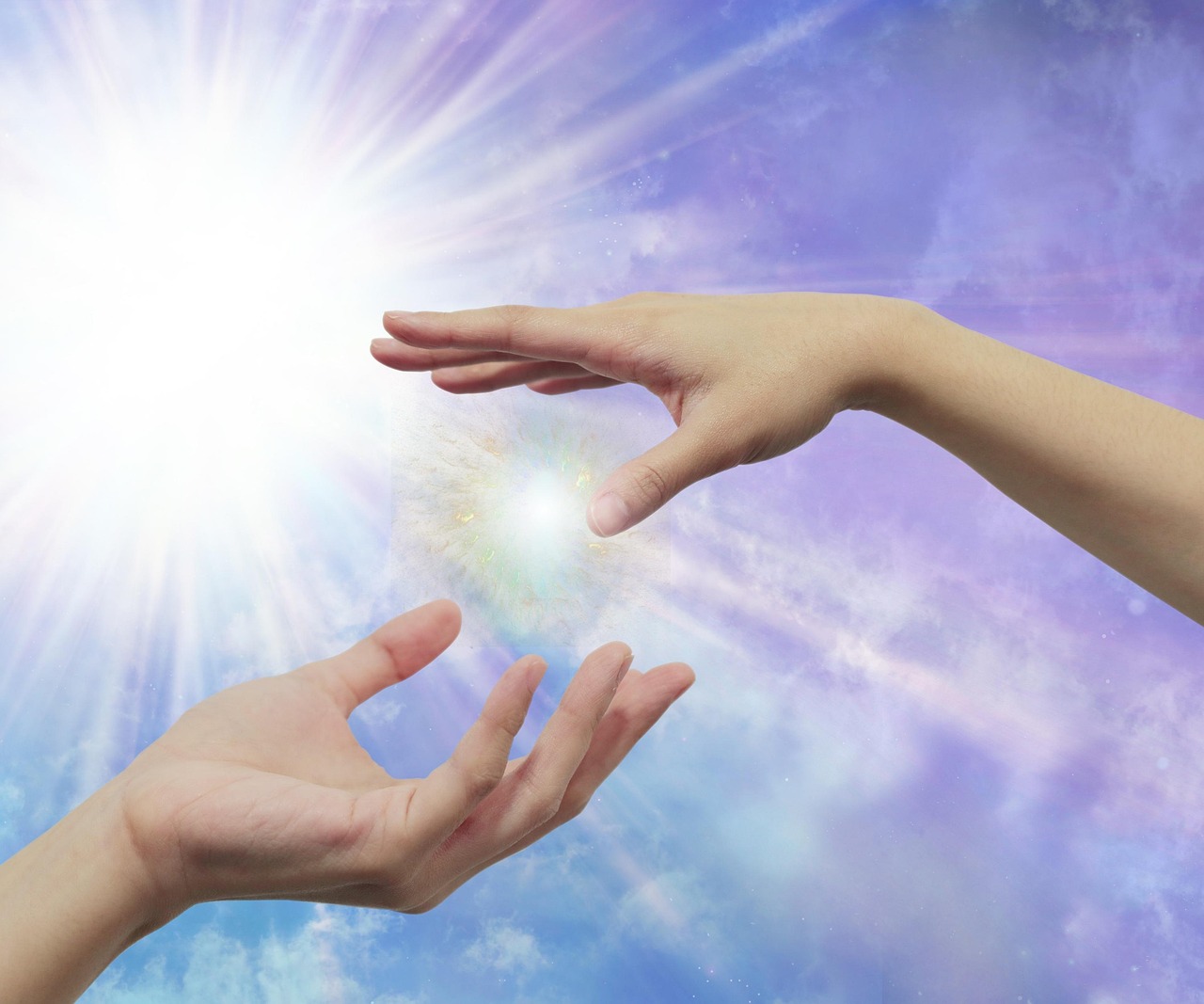 Two hands reach out to each other against a background of shiny violet light. A point of light is concentrating between the hands and another radiates behind them.
