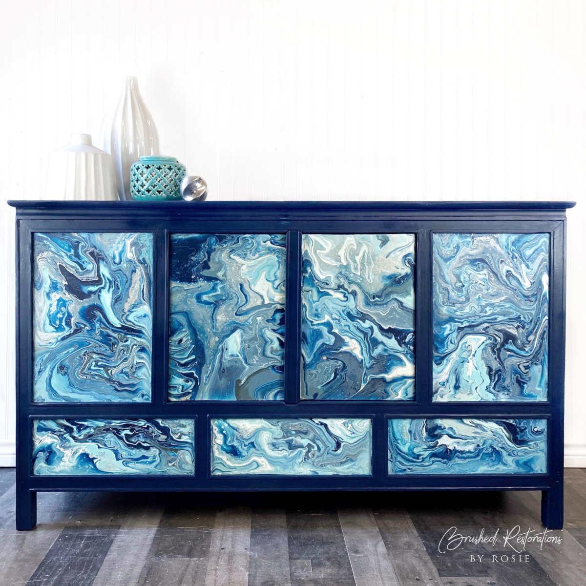 Elegant deep blue resin-poured dresser front, showcasing styles taught in online resin art and paint pouring workshops.