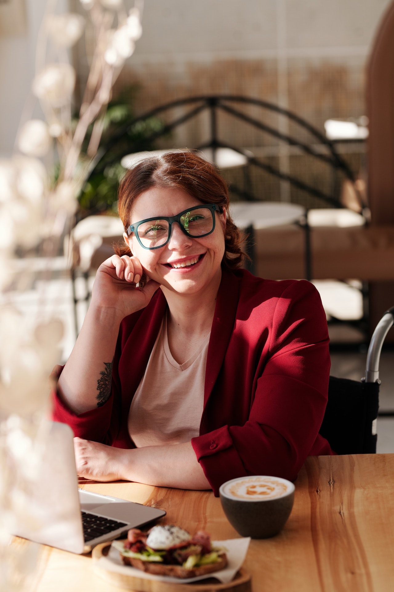 woman smiling because her traffic is growing - image via Pexels / Marcus Aurelius