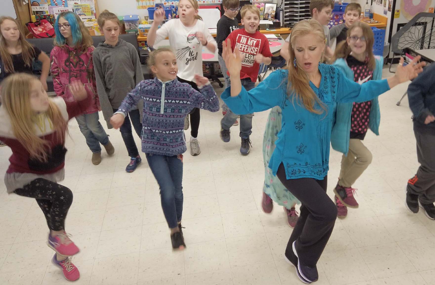 Artist Jensuya teaching Mid East arts residency dance to grade 3 students.