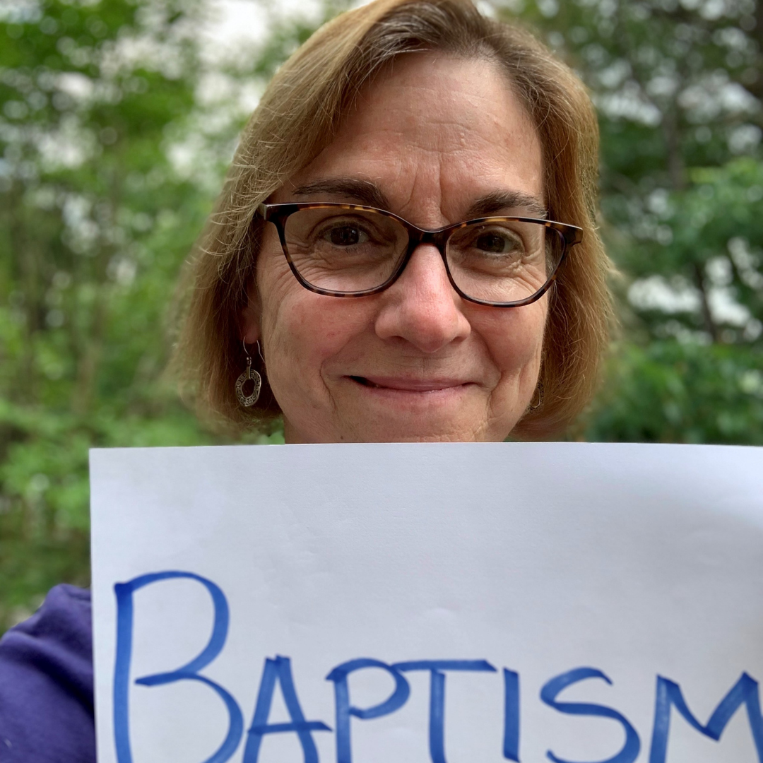 Lisa Kimball holding a sign with the word 