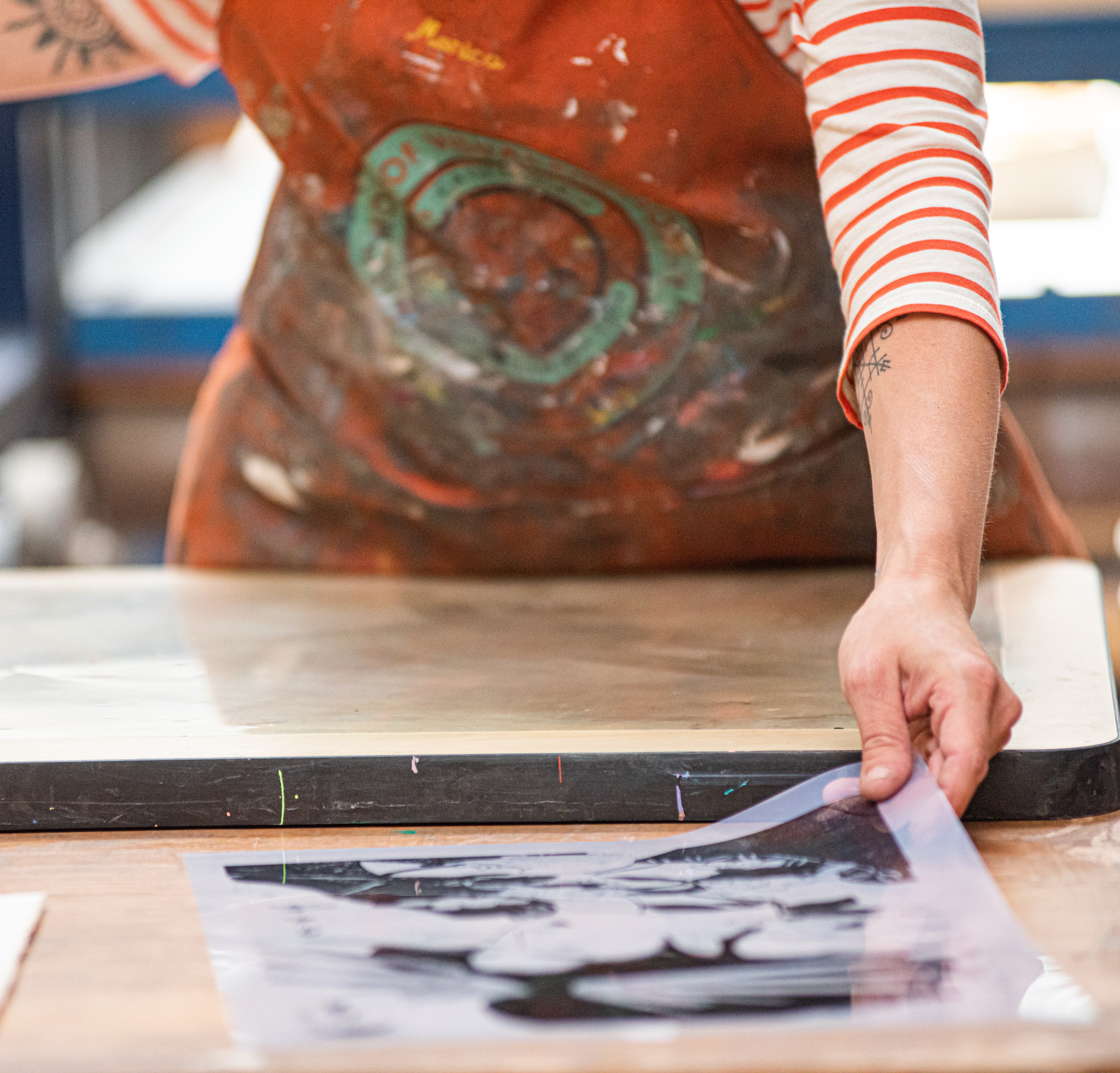woman placing a print on a table.