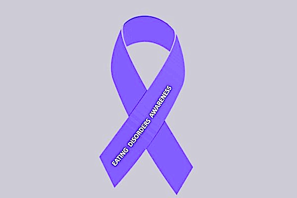 Purple looped ribbon with the words 'Eating Disorders Awareness'