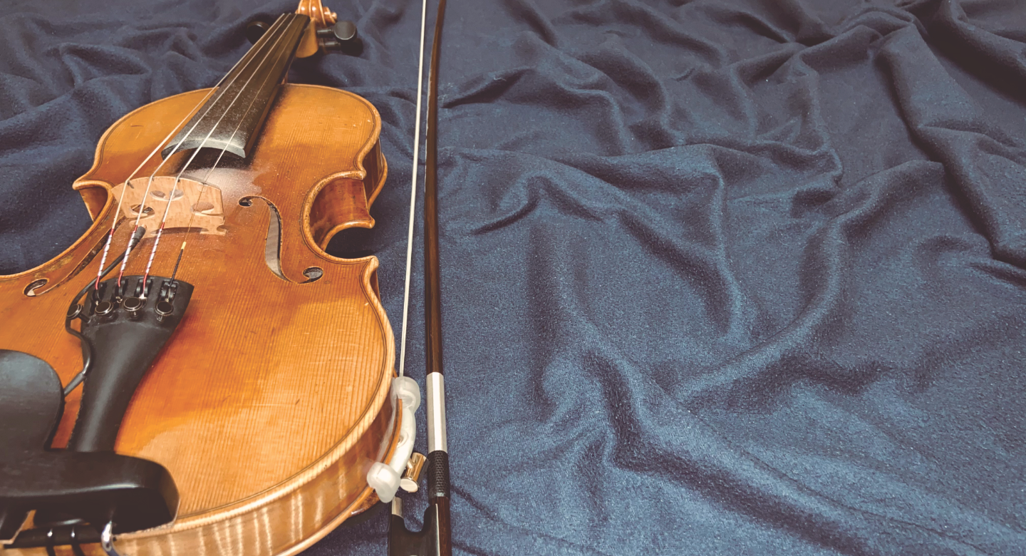 Irish fiddle on dark blue cloth background