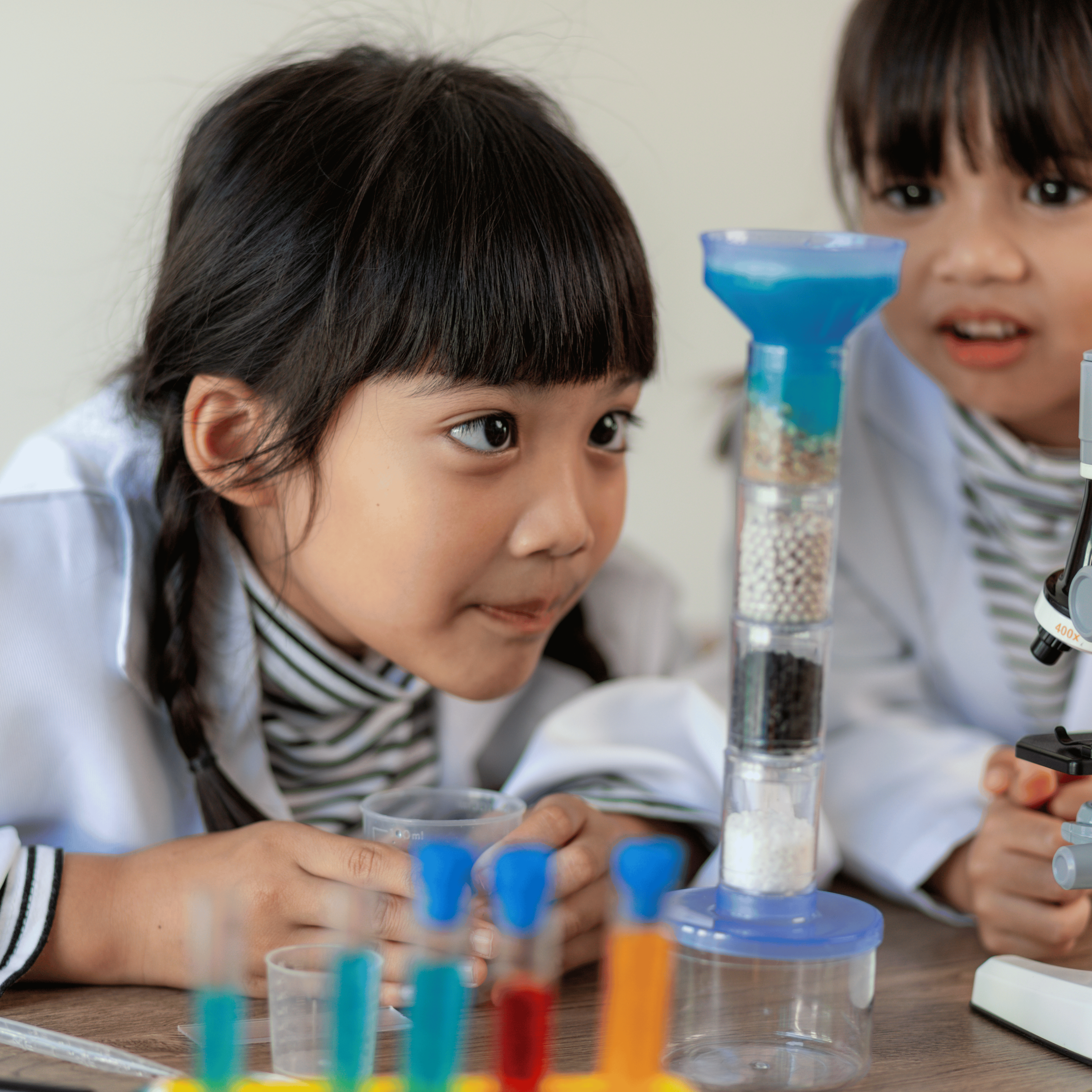 girl student looking at materials with curiosity in science class