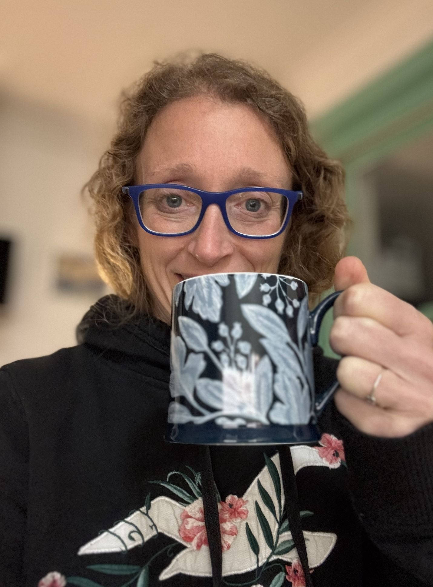 Pooky holding a mug of tea