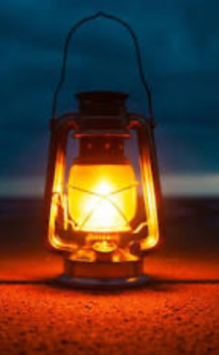 A picture of an old fashioned oil lantern lit in the darkness