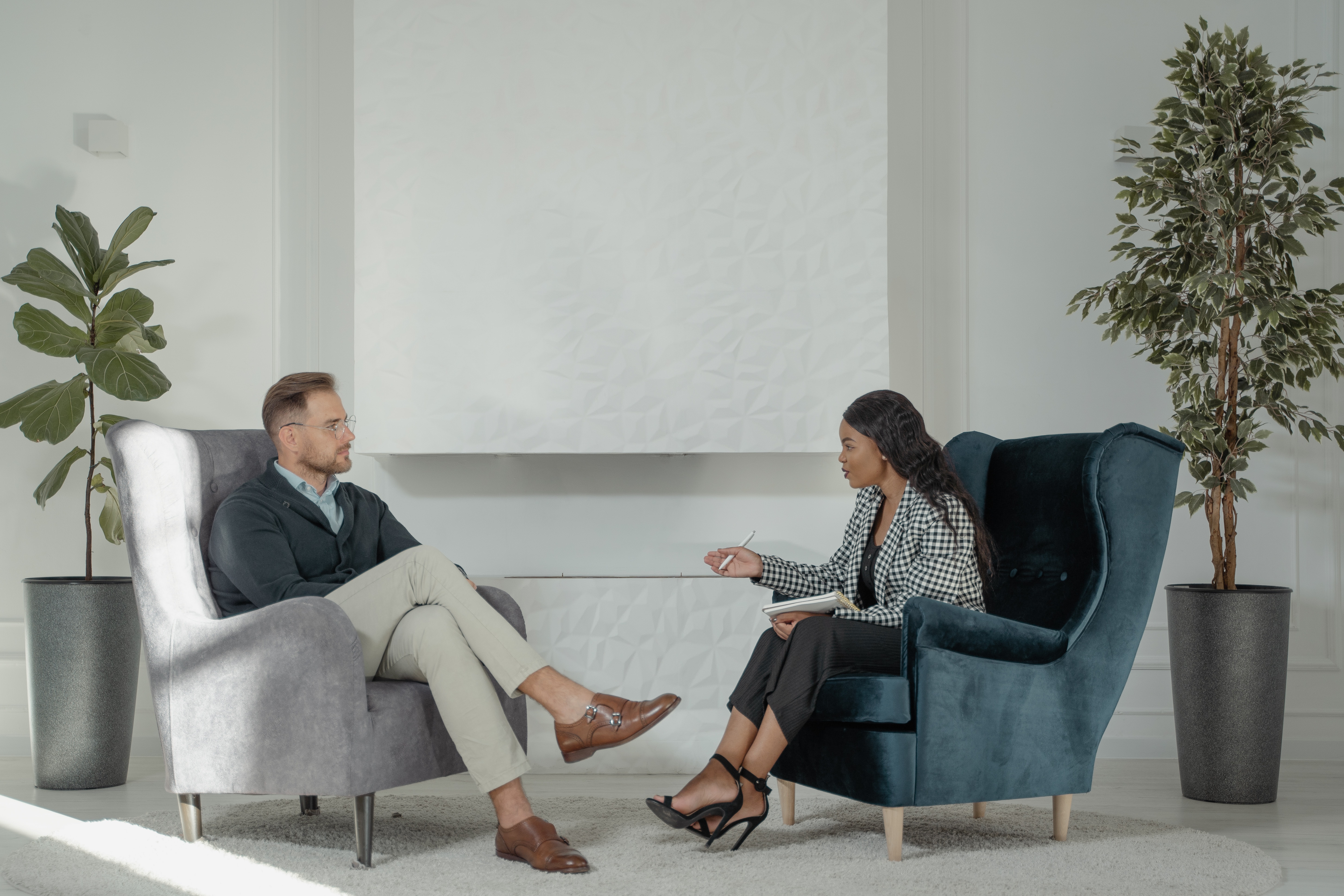 A man and woman sitting in office having a conversation