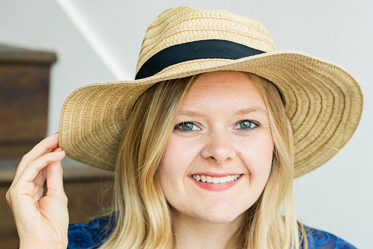 blonde woman wearing a wide brimmed hat