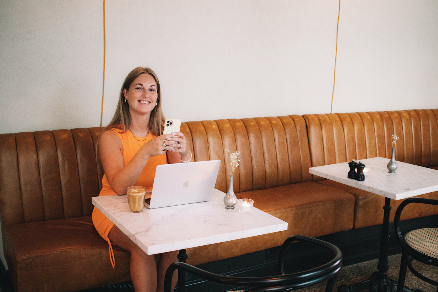 social media manager girl with laptop in white room with white bed