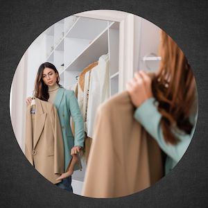 woman matching shoes to jacket in front of mirror