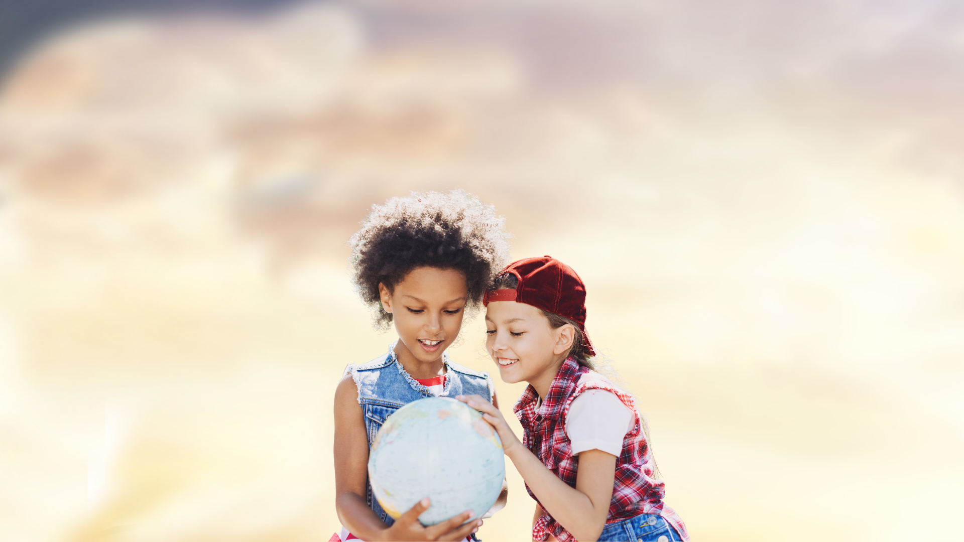 Two girls looking at globe