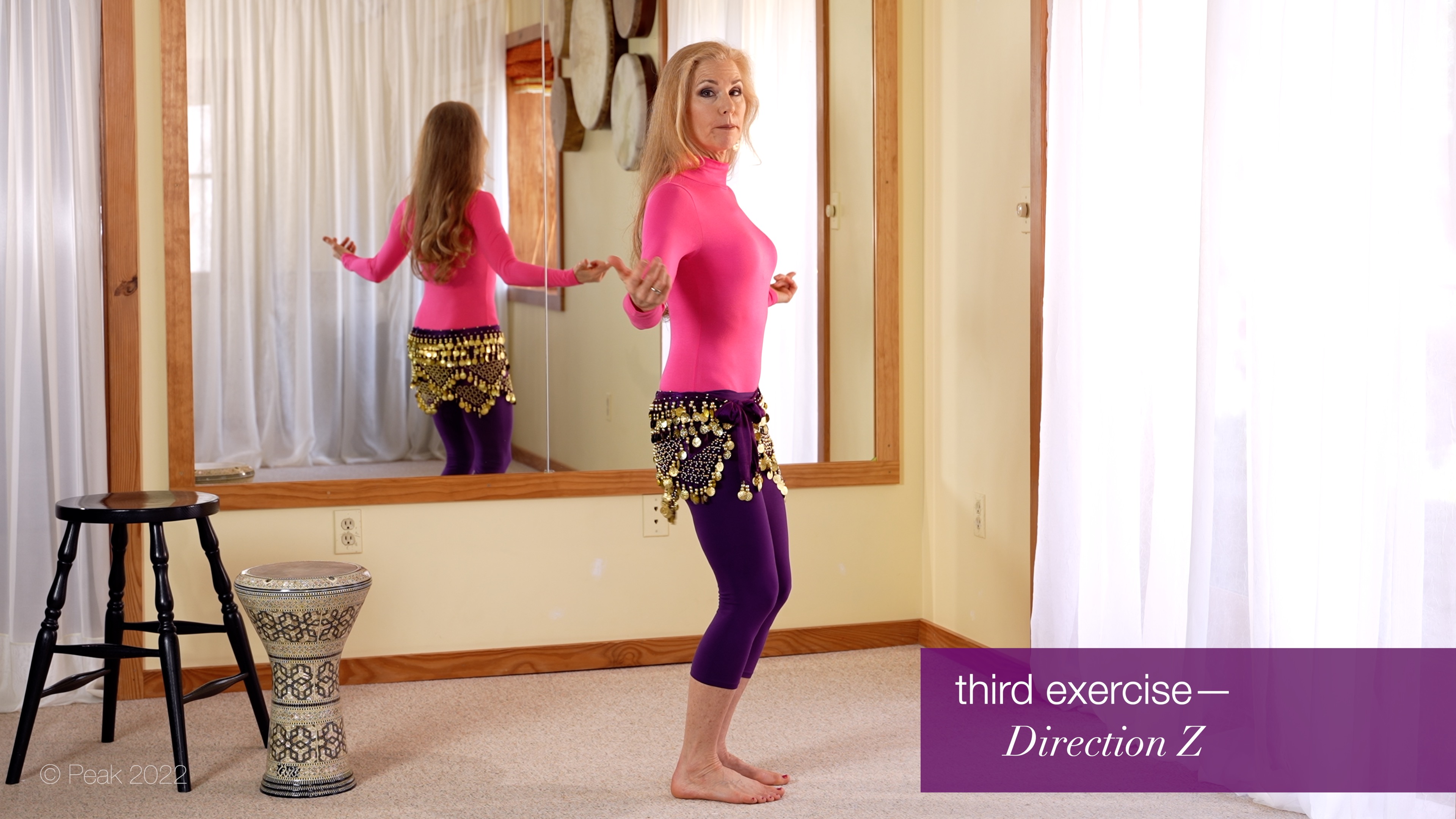 belly dance teacher Jensuya in studio with drum