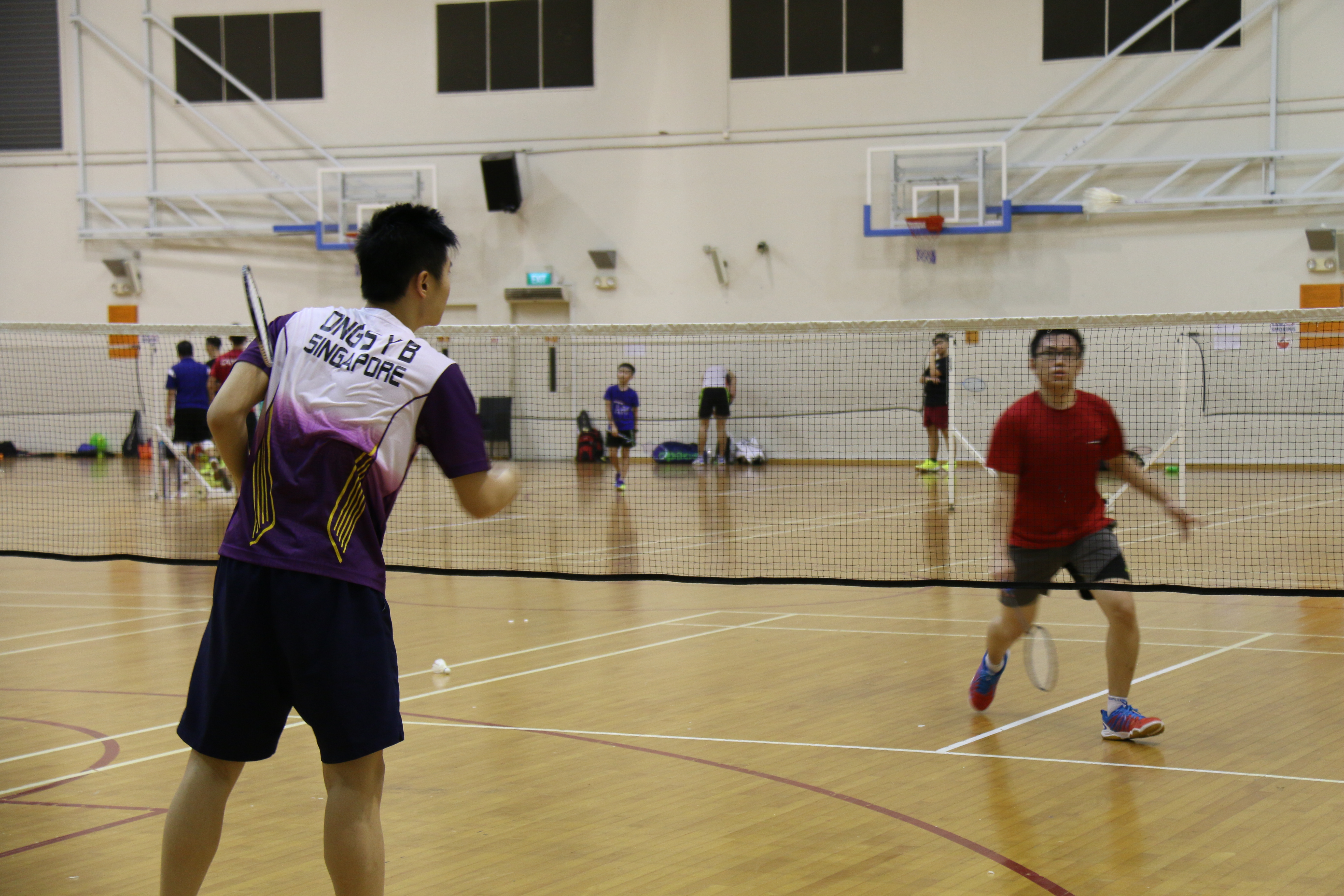 Bernard Ong feeding Leon during badminton training