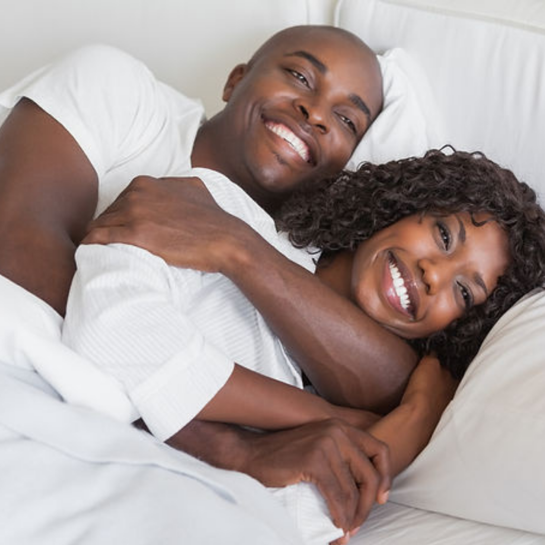 Happy Black couple in bed 