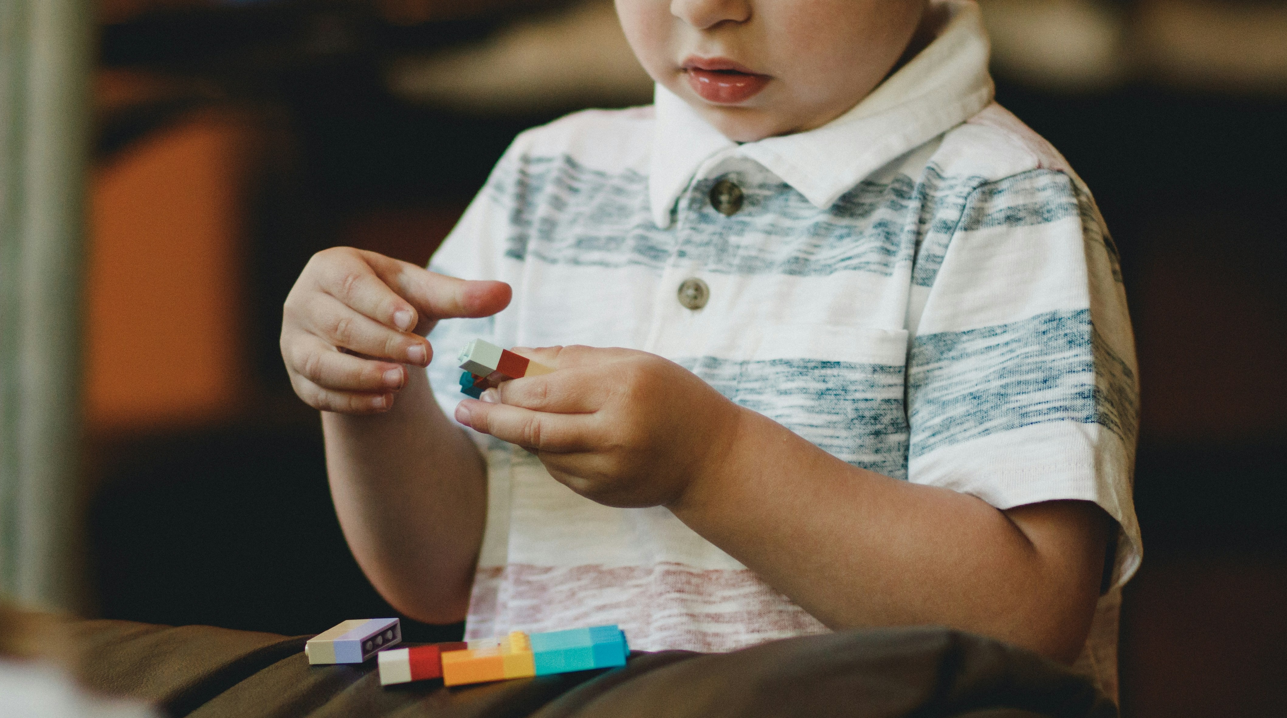 Child playing with Lego blocks