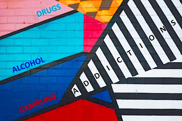 Abstract painting on a wall with the words &#39;Addictions&#39;, &#39;Alcohol&#39;, &#39;Gambling&#39; and &#39;Drugs&#39; 