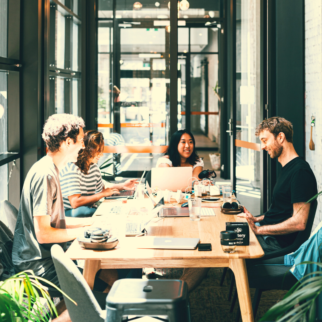 Four people sitting around a conference table