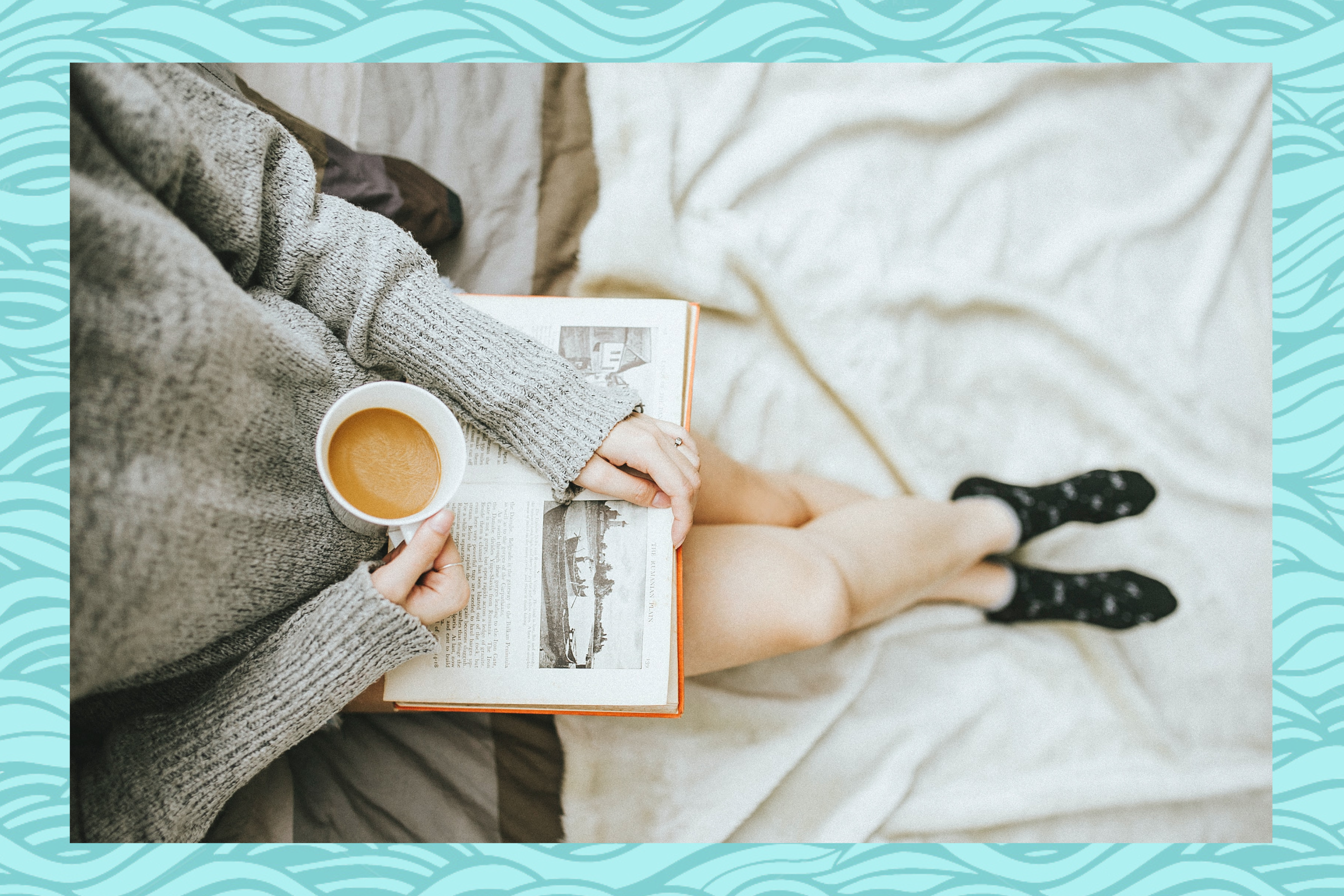 pregnant woman reading book cup of tea