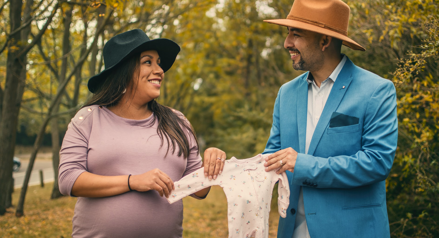 Couple holding onesie