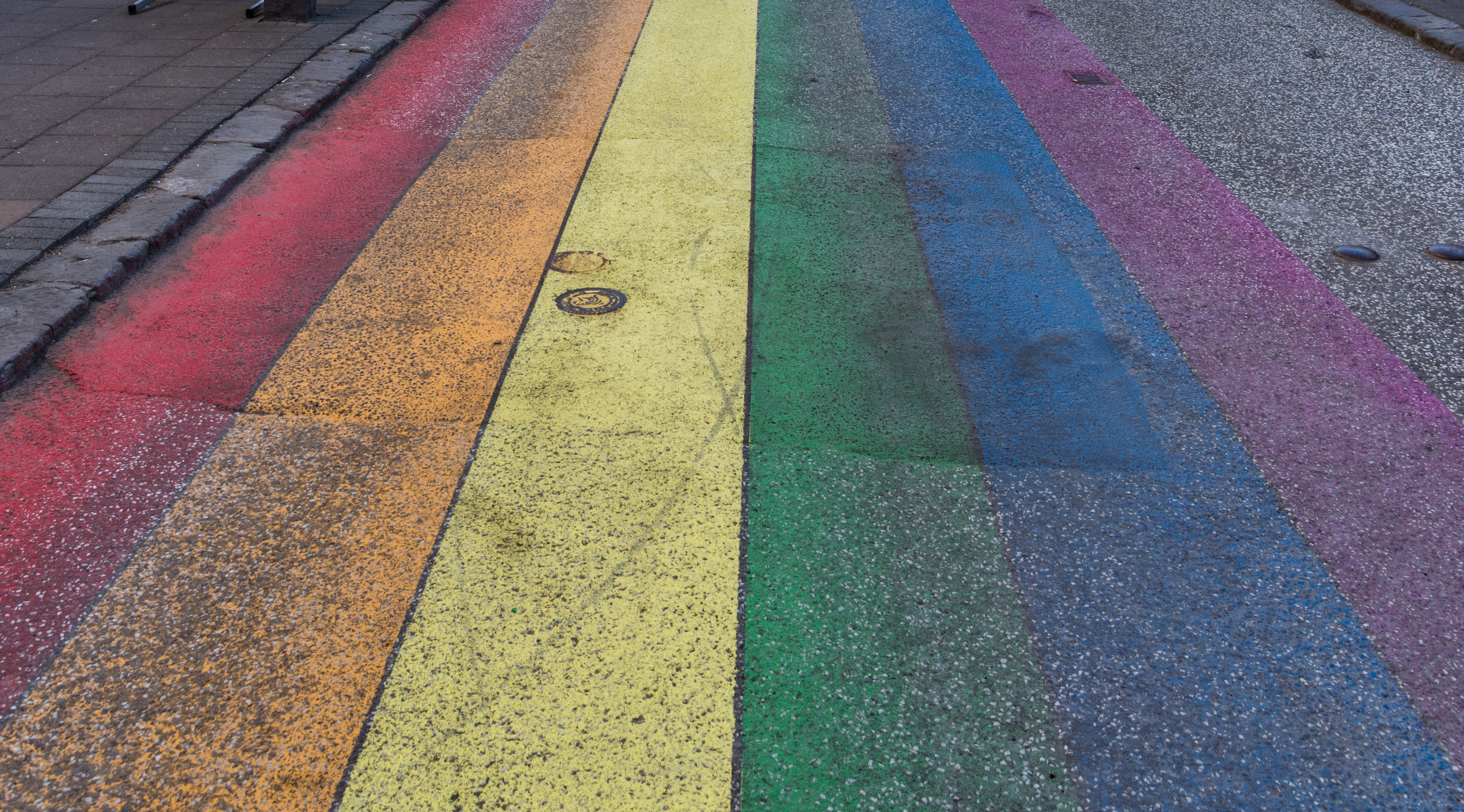 paved road painted with a rainbow