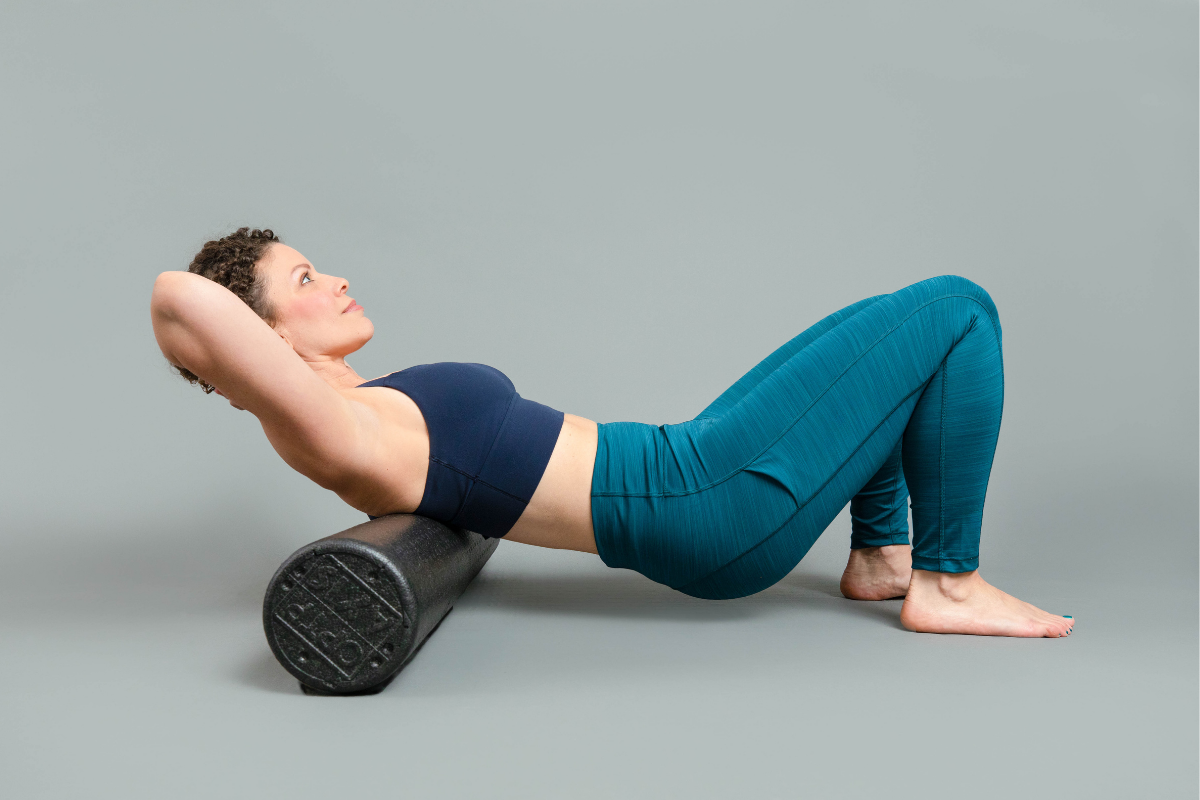 Female rolling mid back on foam roller