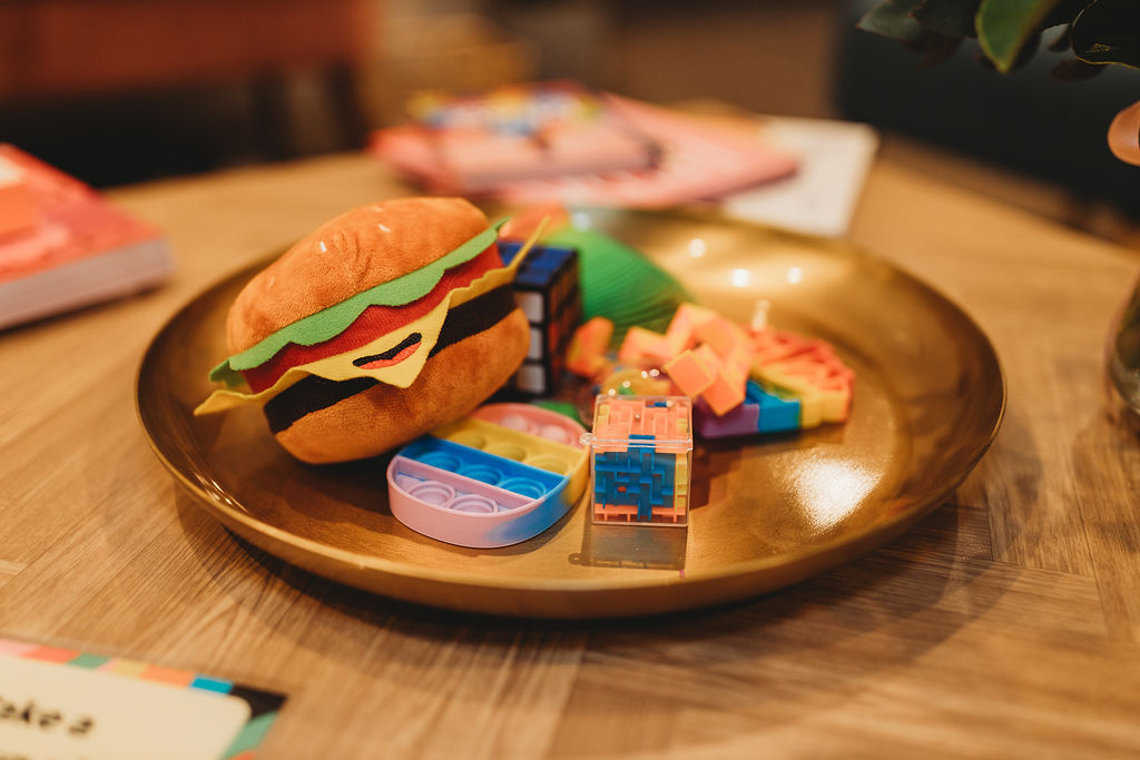 Gold platter on table with fidget toys 