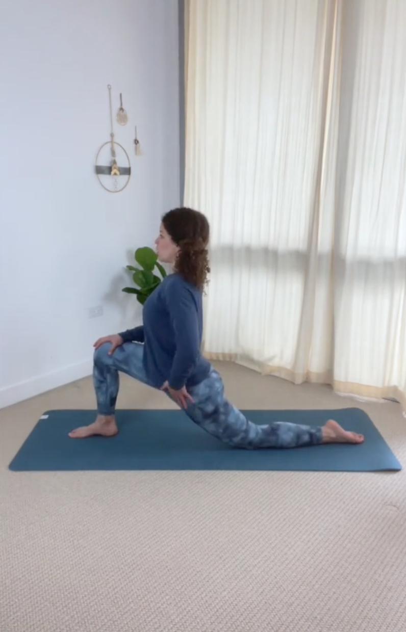 Lady stretching front of left hip by kneeling left knee on yoga mat