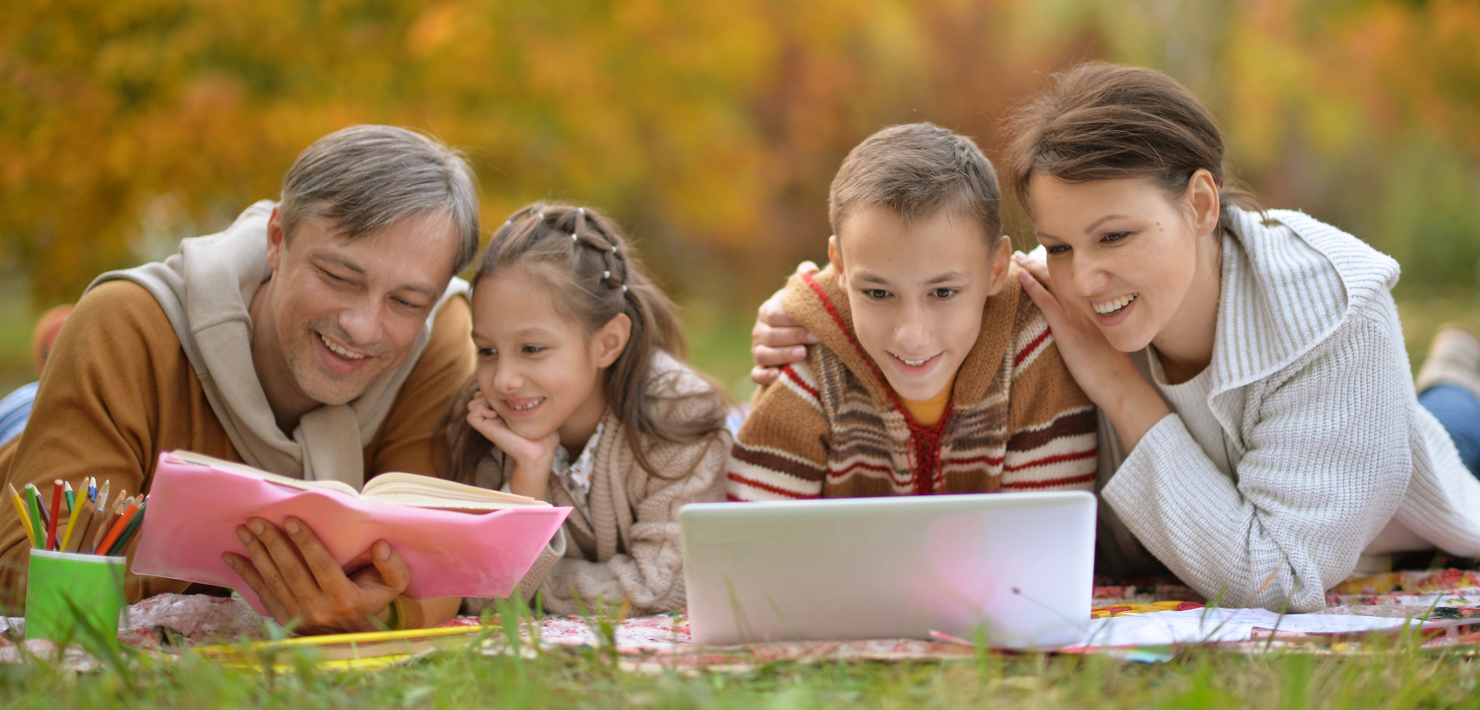 Family of Four Reading Outside