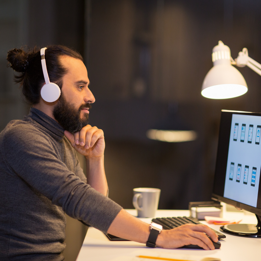 Man with headphones working on computer