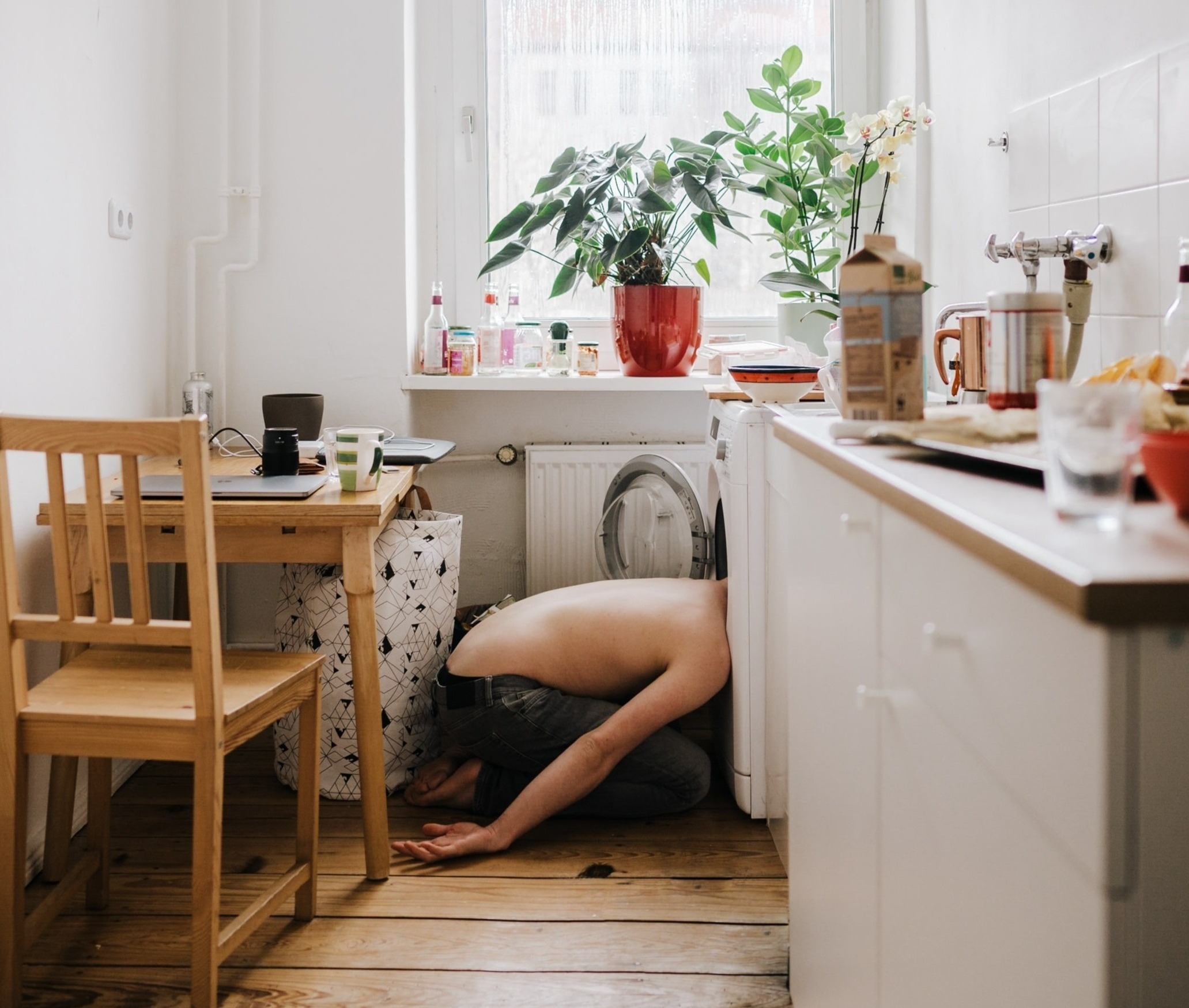 person with head stuck in a washing machine