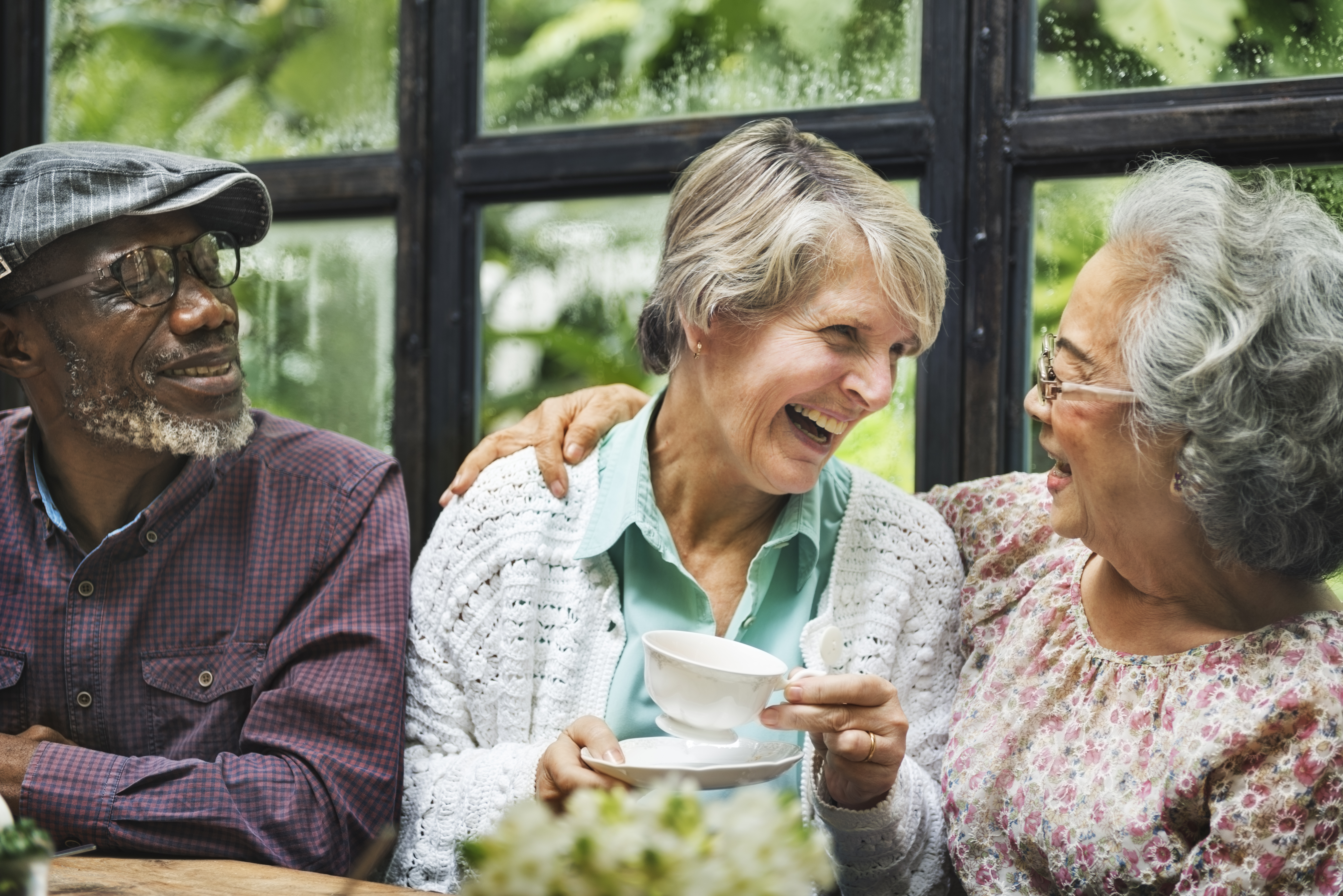 Retired friends enjoying a cup of tea together