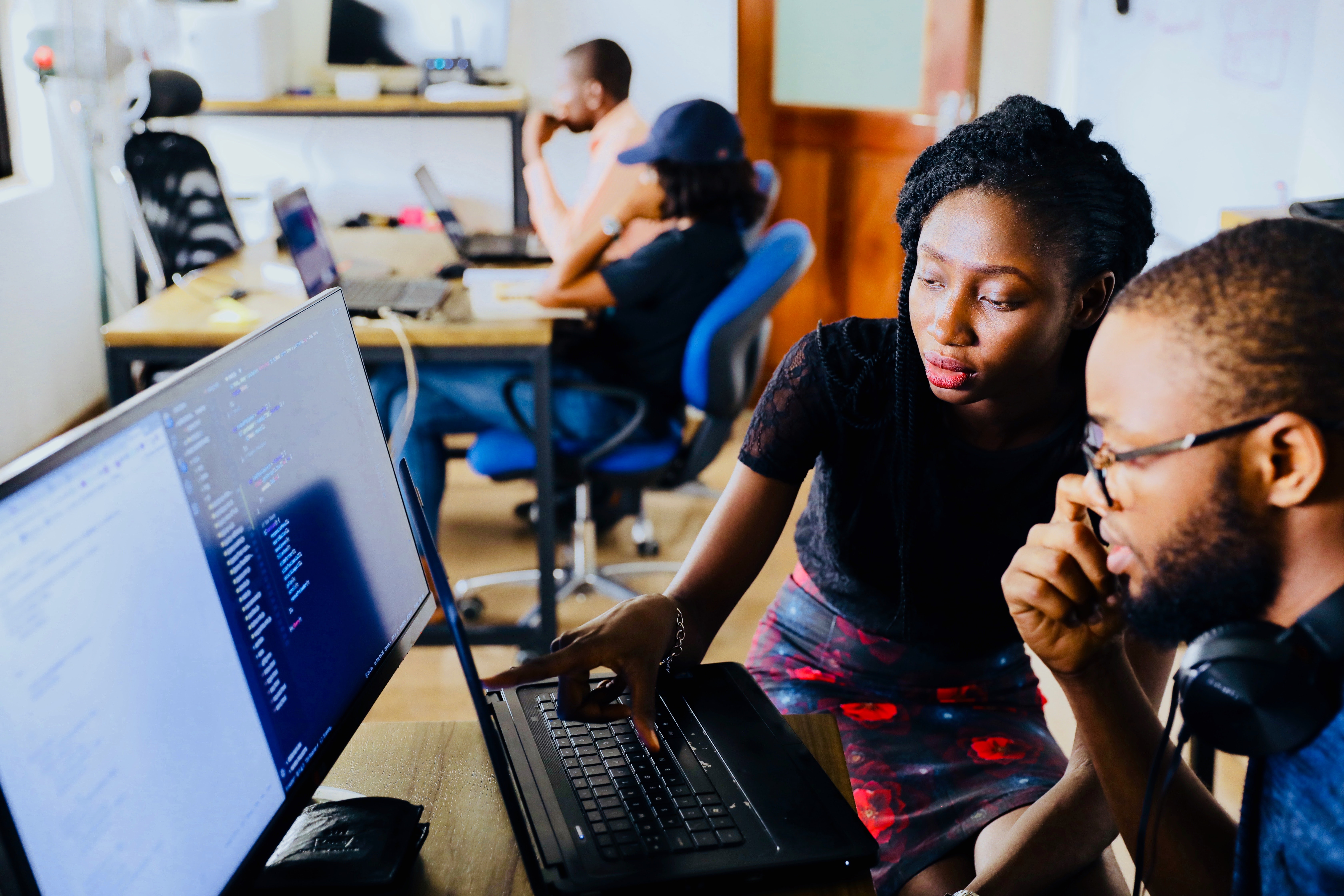 Man and woman sitting in front of computer