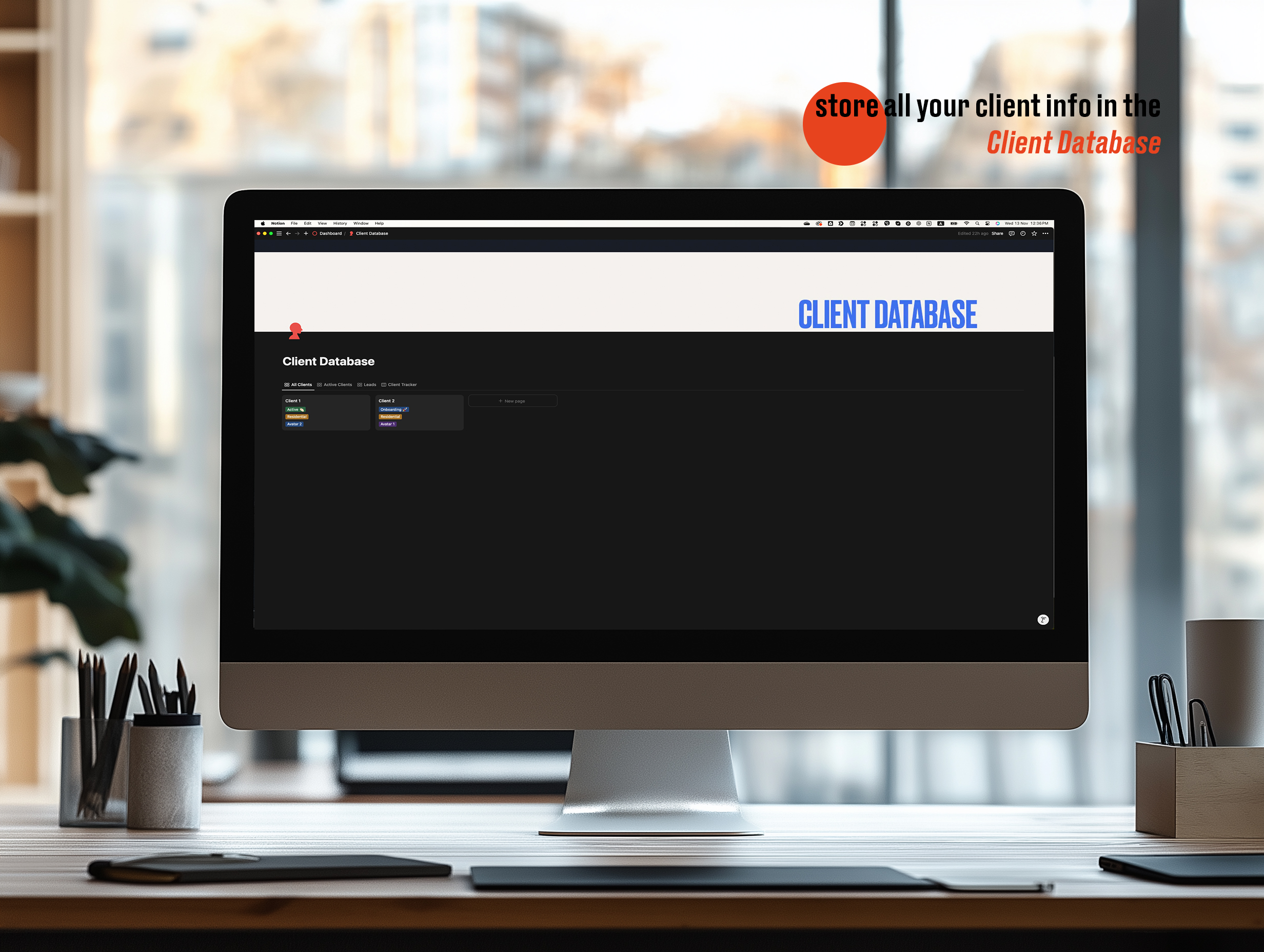 A computer screen displaying a Notion workspace labeled Client Database with a dark interface. The database has sections for client information, organized with tabs labeled Active Clients and Client Tracker. A caption in the top-right corner reads, Store all your client info in the Client Database, with Client Database highlighted in orange. The computer is set on a minimalist desk with office supplies, and a blurred office window background provides natural light.