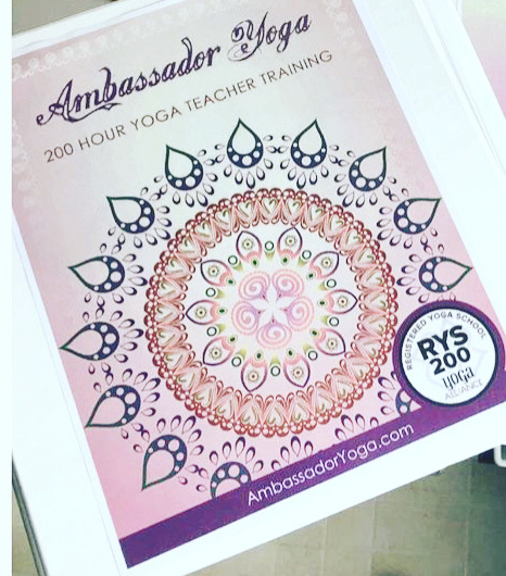 the cover of the yoga teacher training manual has a colourful mandala and the Yoga Alliance RYS symbol