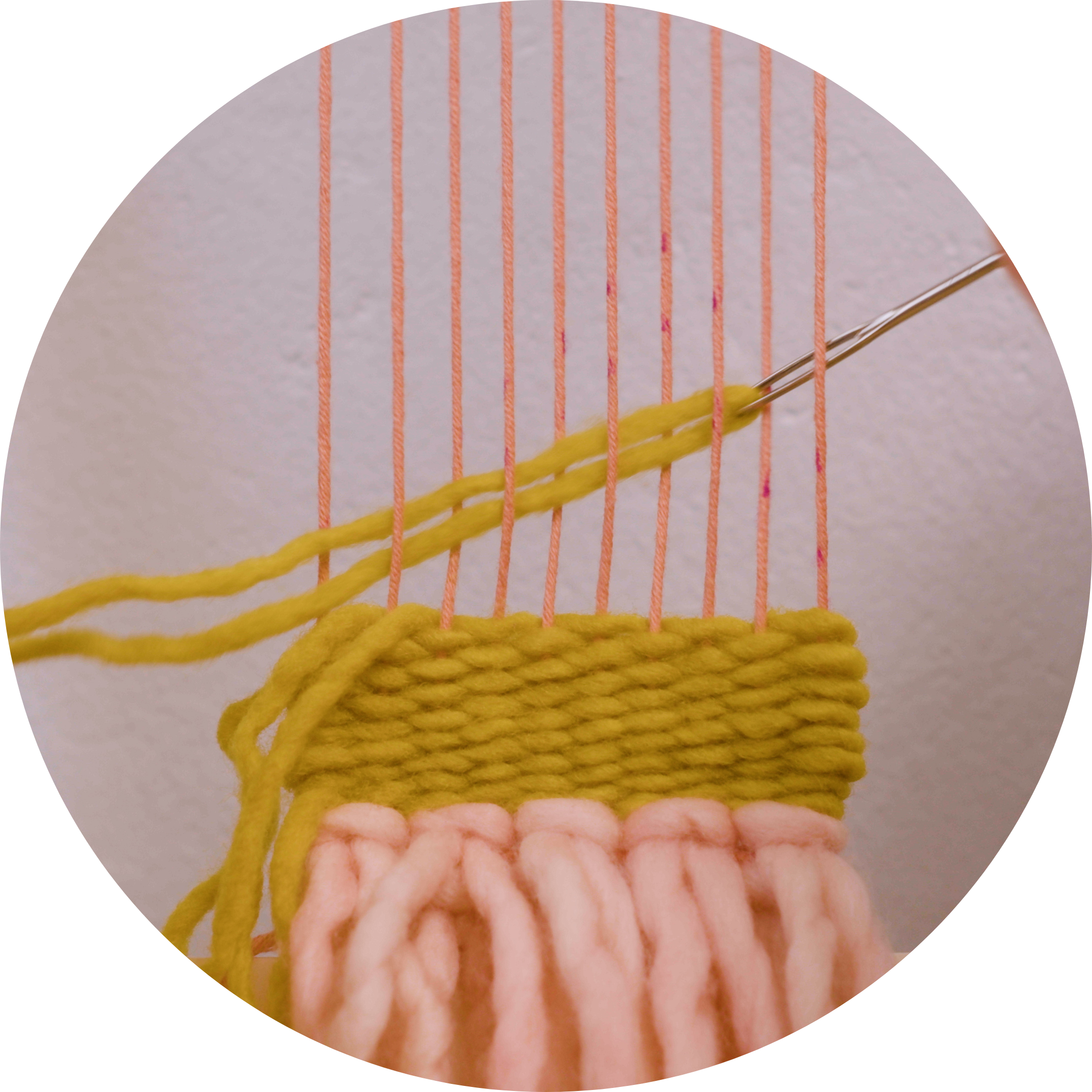 Close up of yellow yarn weaving in progress