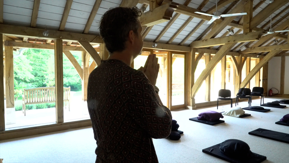 Martin Aylward bowing in meditation hall