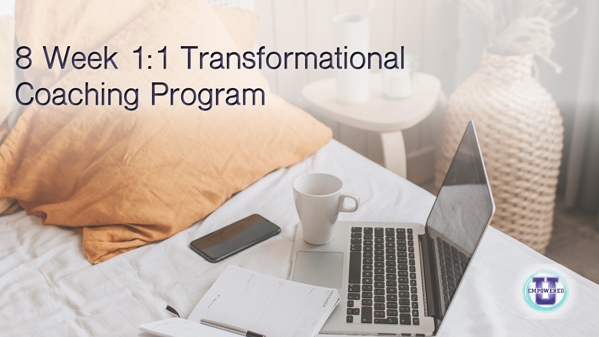 Transformational coaching program image of laptop, phone, notebook, and mug sitting on bed