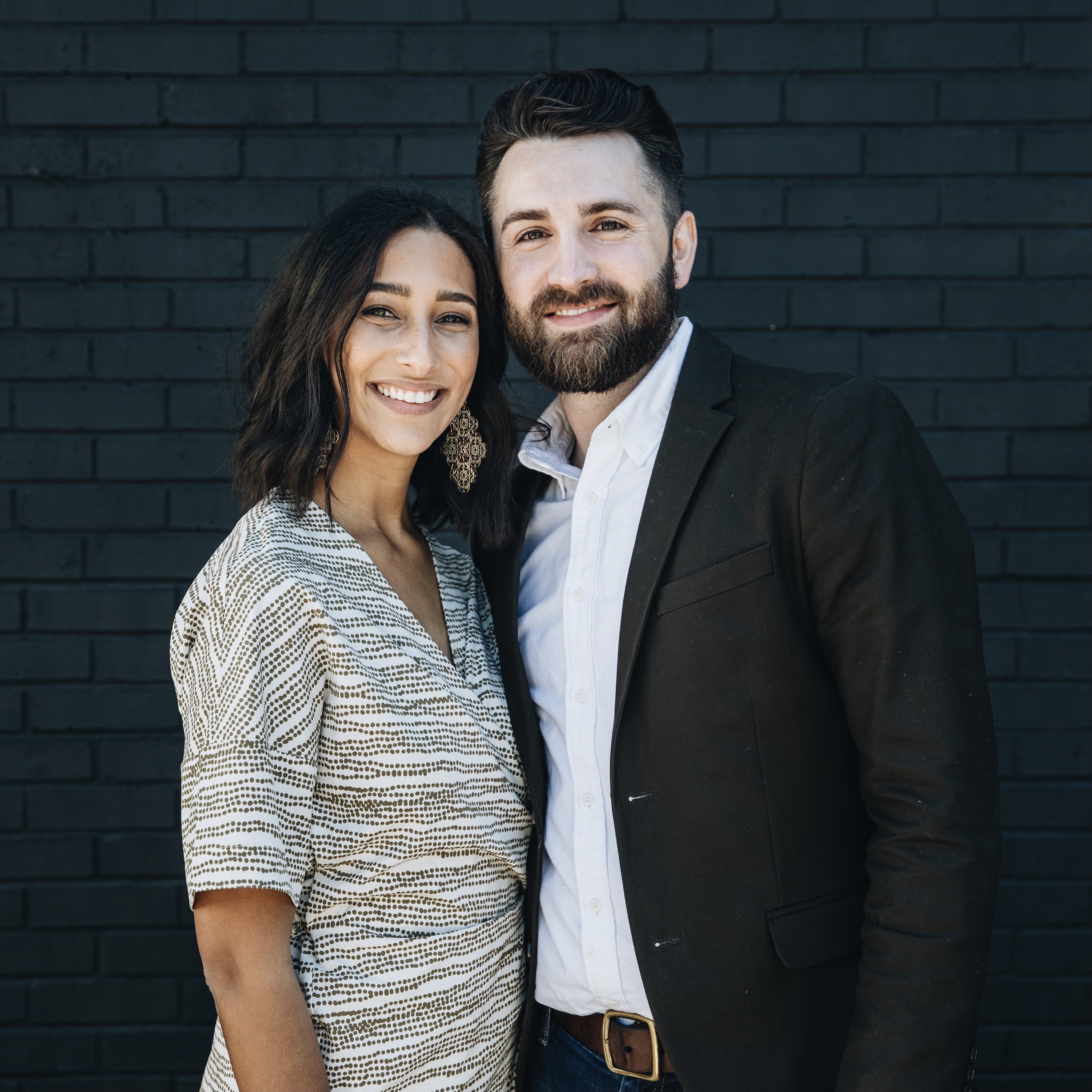 Smiling couple hold hands