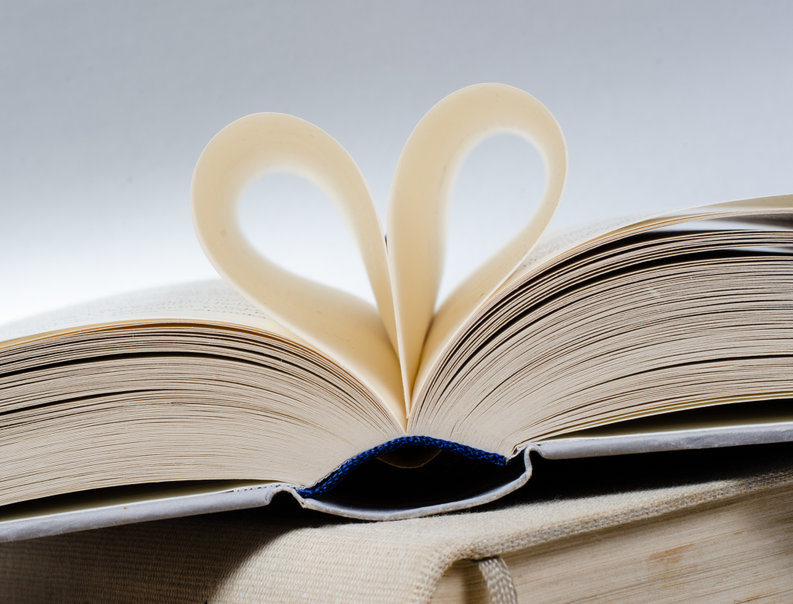 picture of open book with pages shaping a heart
