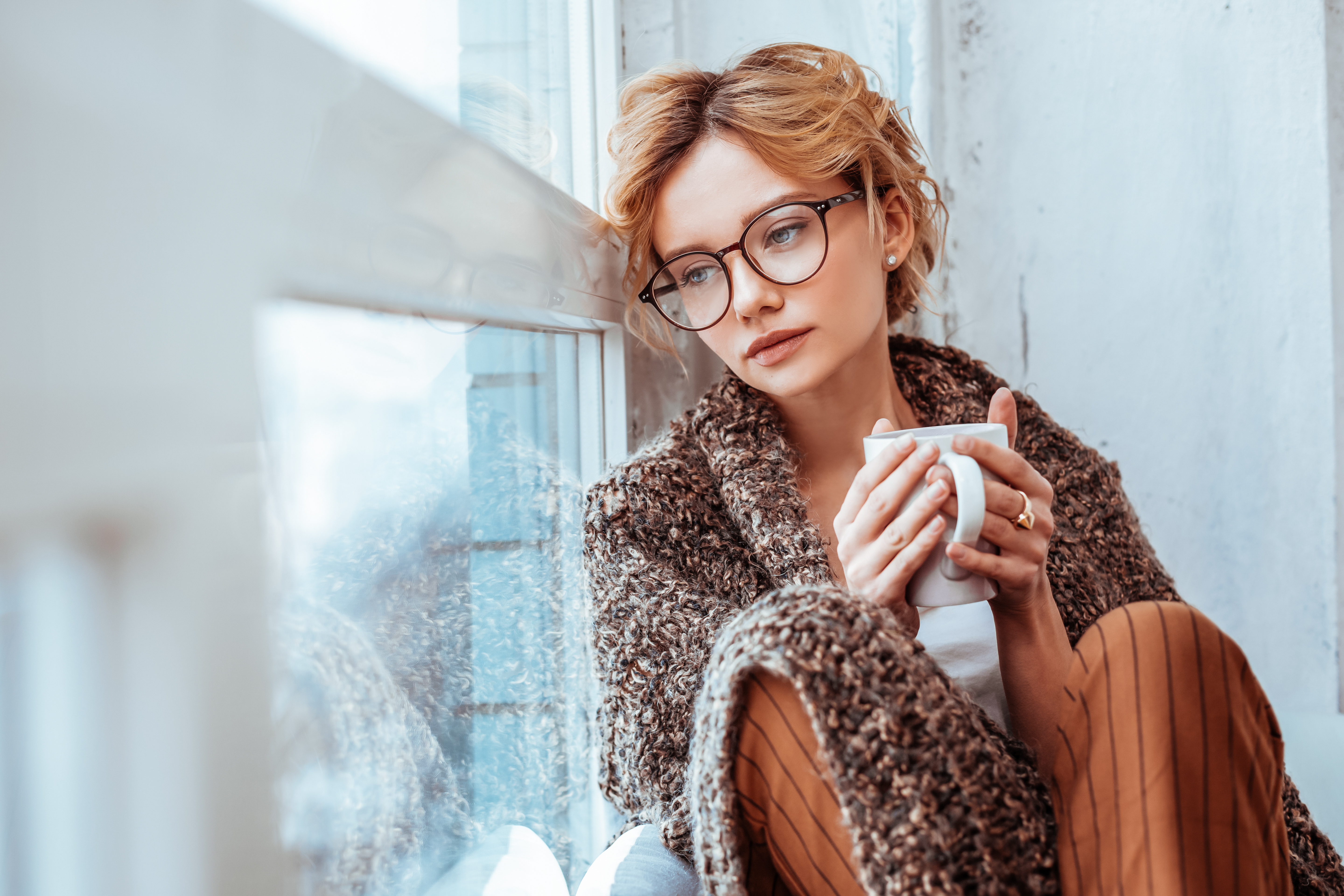 Sad woman alone with cup of coffee