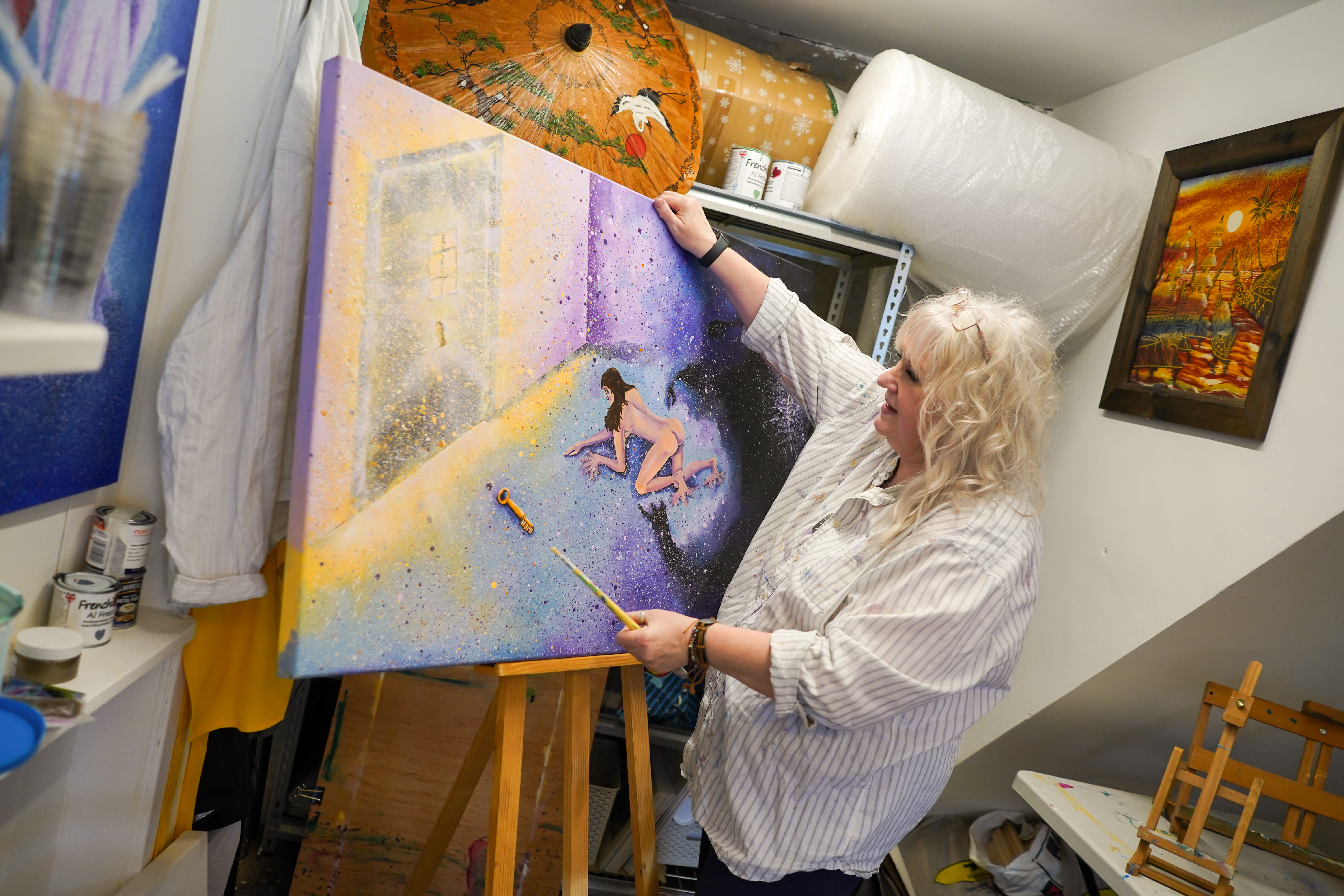 an artist with an easel and large canvas