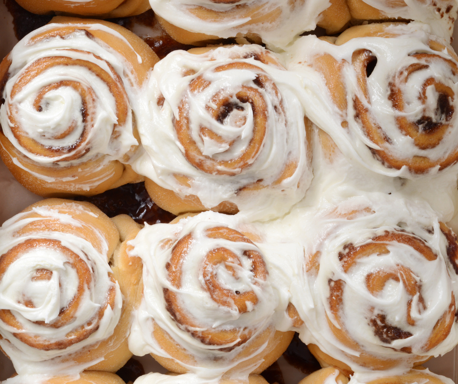 Top view of baked cinnamon buns with icing