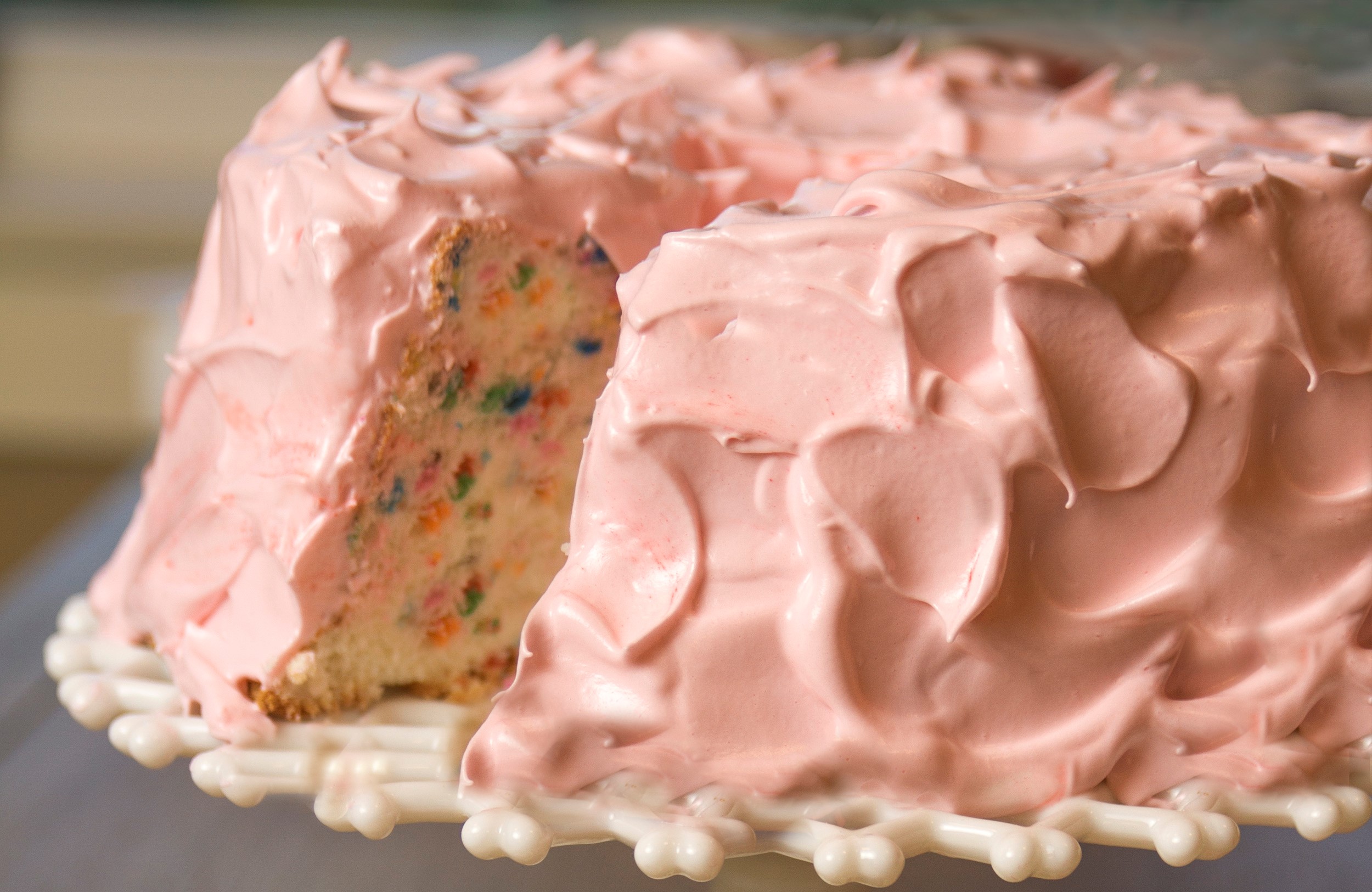 Angel food cake with light pink frosting.