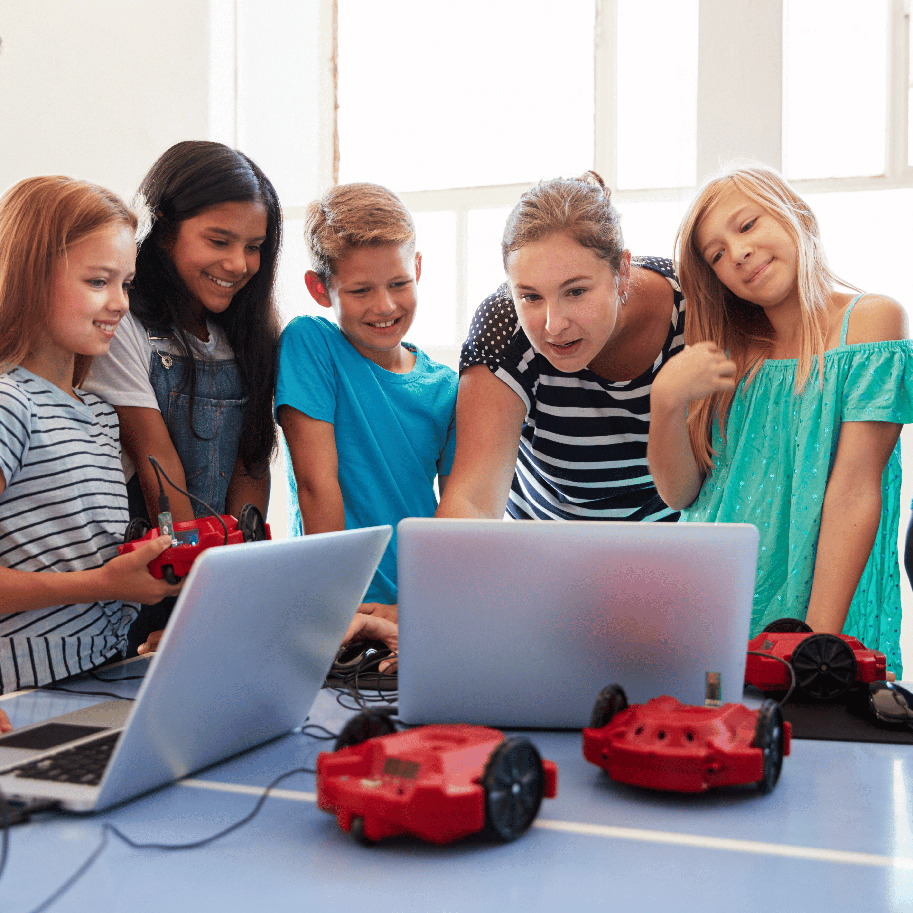 teacher and students working with laptops