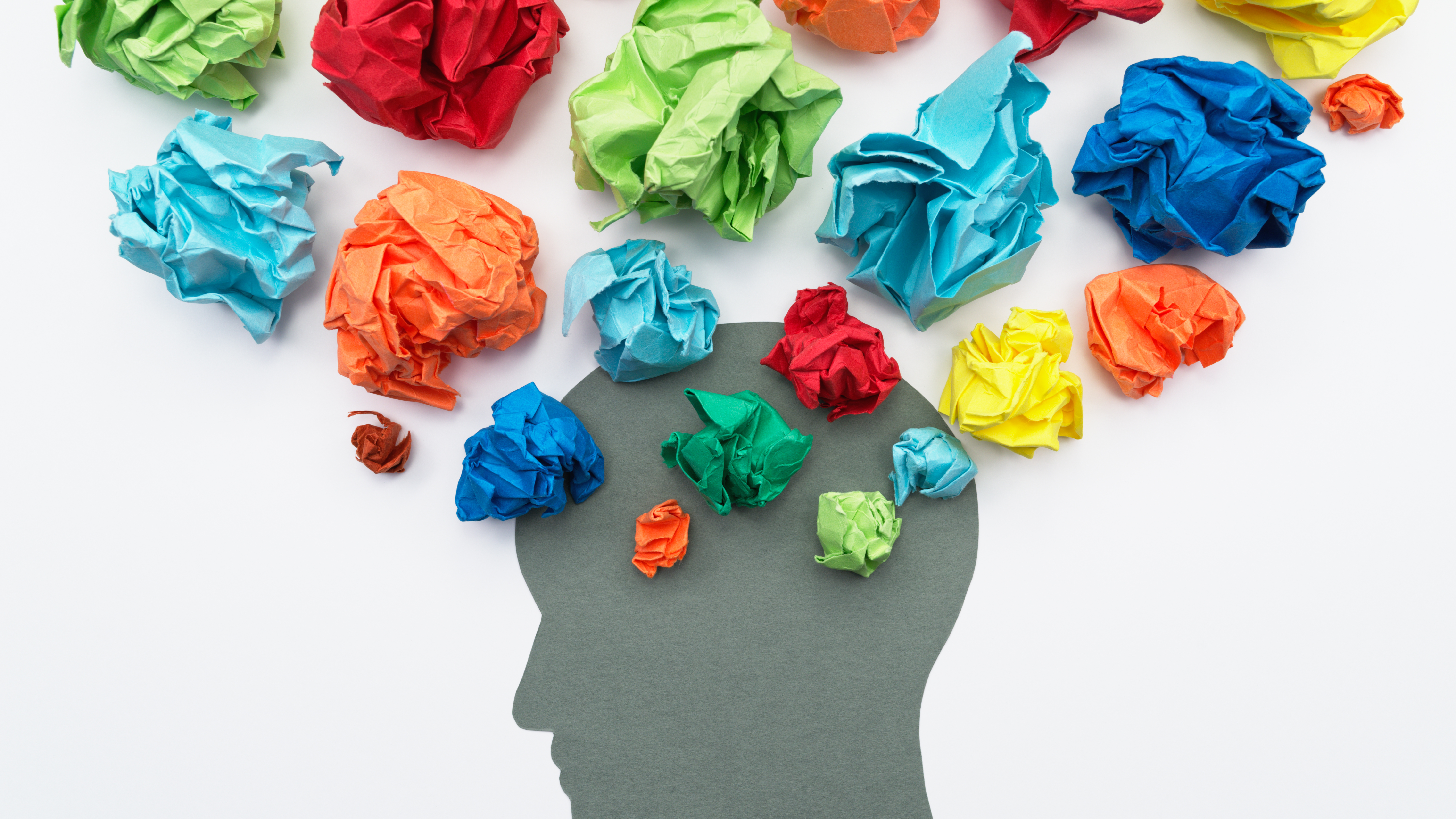 head with crinkled up colored paper leaving brain