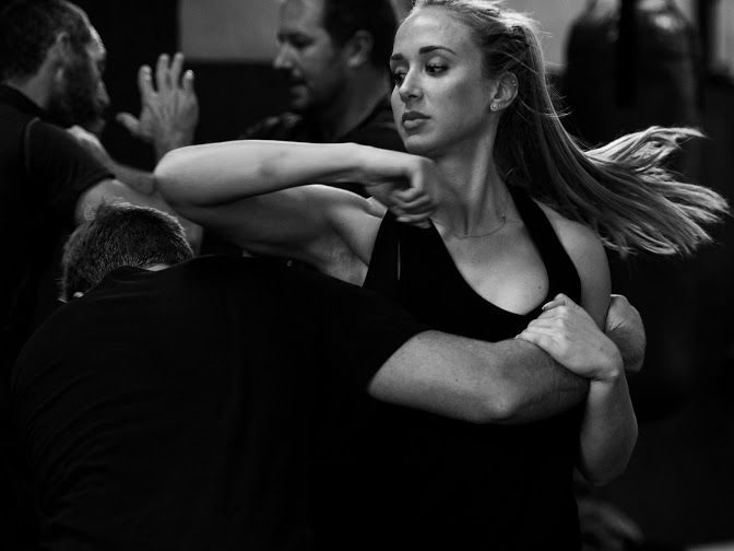Woman practicing self-defence technique against attack