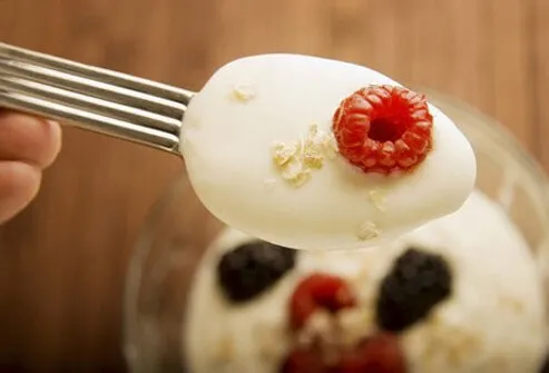 Spoonful of yogurt with berries.